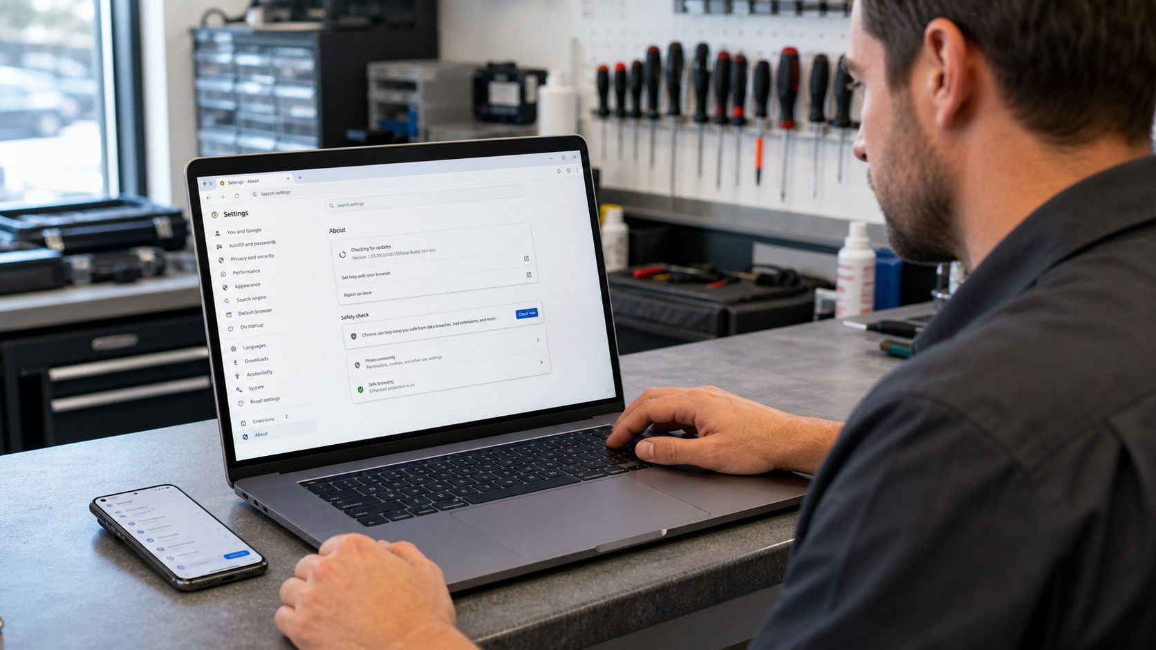 Repair technician confirming a Chrome browser update and relaunch on a customer laptop before collection